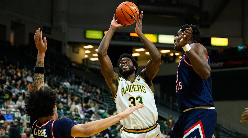 Wright State University's Michael Imariagbe shoots the ball between two Robert Morris University defenders during their game against Robert Morris University on Sunday, Feb. 22, 2026 at the Nutter Center. The Colonials won 81-68. JEREMY MILLER / CONTRIBUTED PHOTO