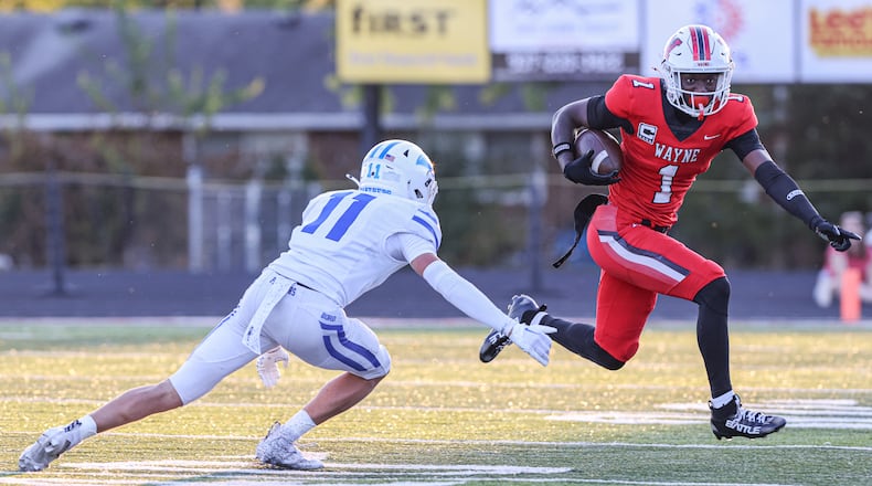 Wayne junior receiver Jamier Brown (right) tries to avoid Springboro's rice Markoff during a Greater Western Ohio Conference game on Friday, Sept. 12 at Heidkamp Stadium. Brown, an Ohio State recruit, had over 250 all-purpose yards and scored two touchdowns. BRYANT BILLING / STAFF