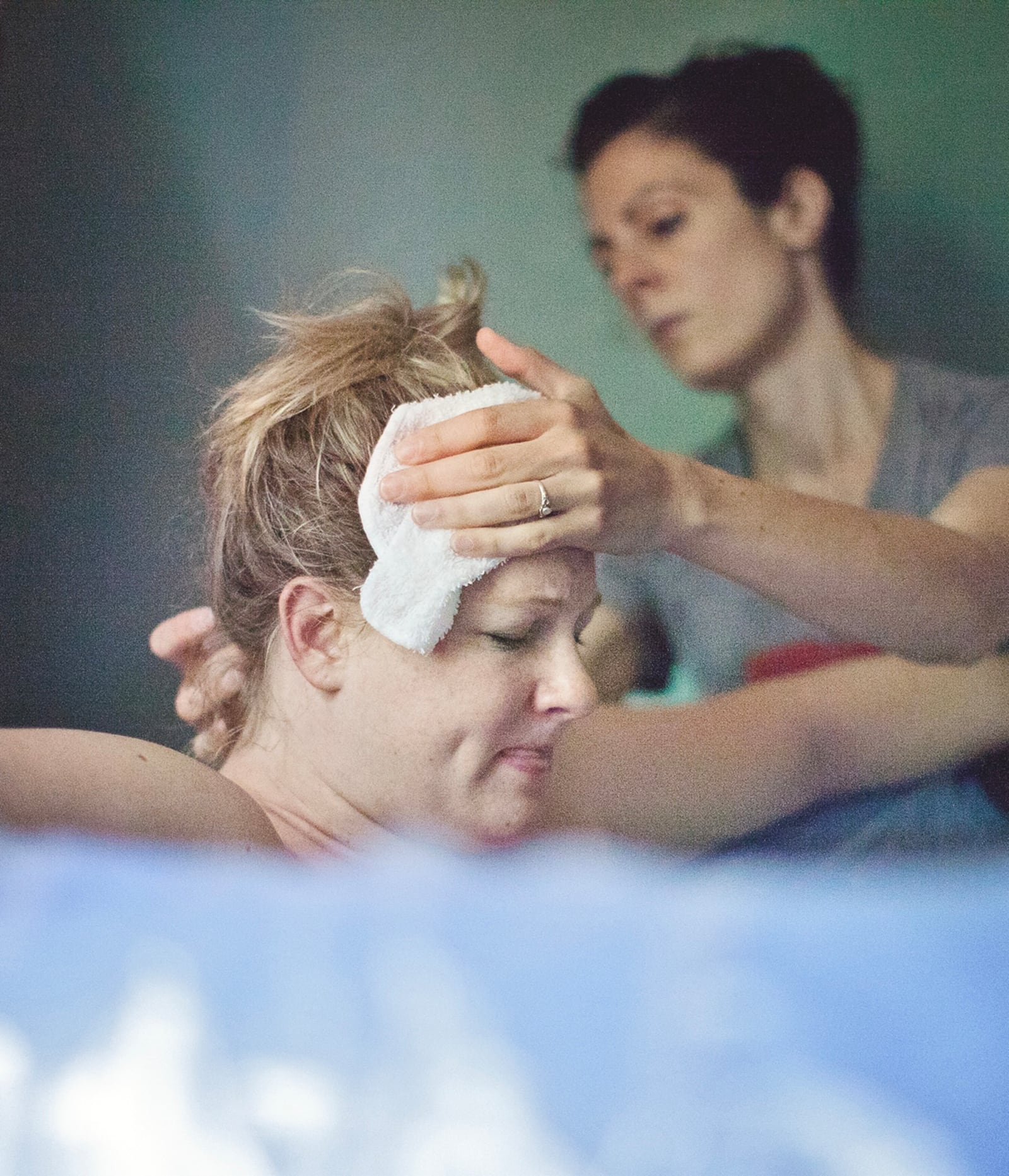 Erica Paulson (rear) supporting mother to be Laura Cousino in labor in 2015. CONTRIBUTED