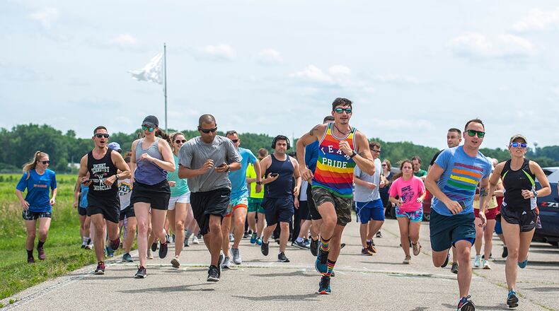 Runners take off from the starting line during the Pride Month 5K, which took them through Huffman Prairie at Wright-Patterson Air Force Base on June 24. U.S. AIR FORCE PHOTO/WESLEY FARNSWORTH