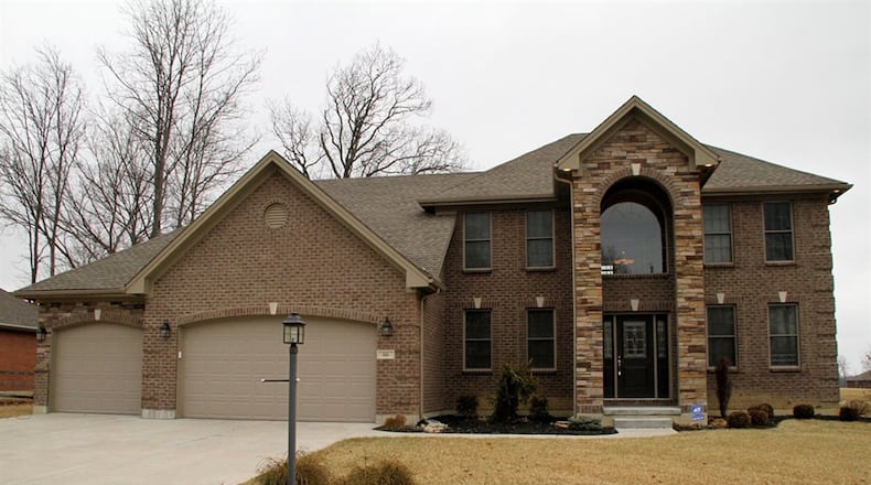 The brick-and-stone home, with 4 bedrooms and about 2,580 sq. ft. of living area, backs up to a common area where there is a pond. The property includes a 4-car garage with 2 separate bay doors. CONTRIBUTED PHOTOS BY KATHY TYLER