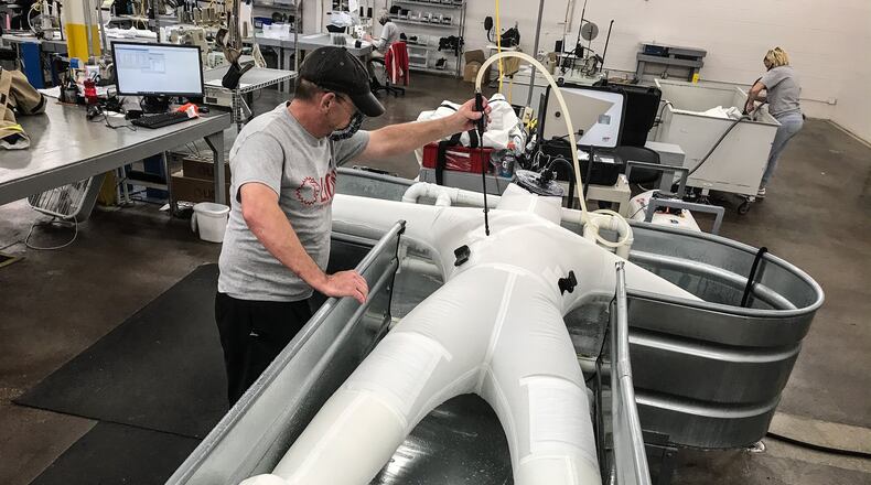 A worker at Lion's Janney Road facility tests a newly-made chem-bio suit for leaks.