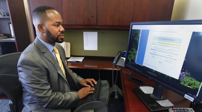 Montgomery County Recorder Brandon McClain demonstrates a new fraud alert system that will notify enrolled property owners if changes are made to certain property records. CHRIS STEWART / STAFF