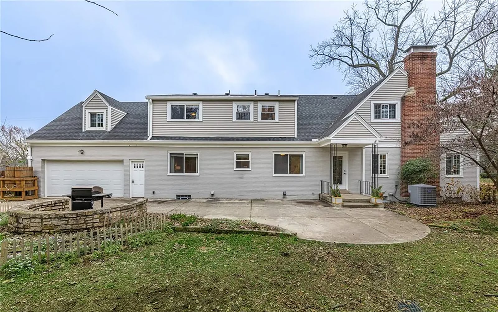 The back of the home has a concrete patio, stone accent wall and second garage door. The lot is professionally landscaped with perennials and pollinator attracting plants. CONTRIBUTED
