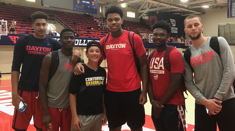 Dayton freshmen (from left to right) Obadiah Toppin, Jalen Crutcher, Jordan Pierce, Jordan Davis and Matej Svoboda pose for a photo with a fan at a basketball camp on July 20, 2017, at UD’s Frericks Center. Photo courtesy of Chris King