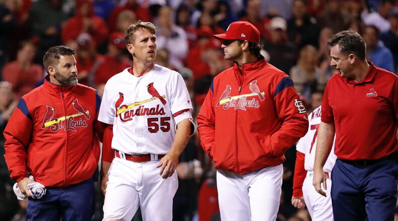 The Cardinals' Stephen Piscotty (55) walks off the field after being injured while scoring during the fifth inning against the Chicago Cubs on Tuesday, April 4, 2017, in St. Louis. (AP Photo/Jeff Roberson)