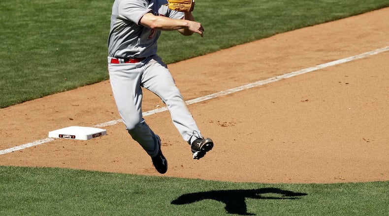Cincinnati Reds third baseman Scott Rolen throws out San Francisco Giants’ Buster Posey during the seventh inning of a baseball game in San Francisco, Wednesday, Aug. 25, 2010. (AP Photo/Marcio Jose Sanchez)
