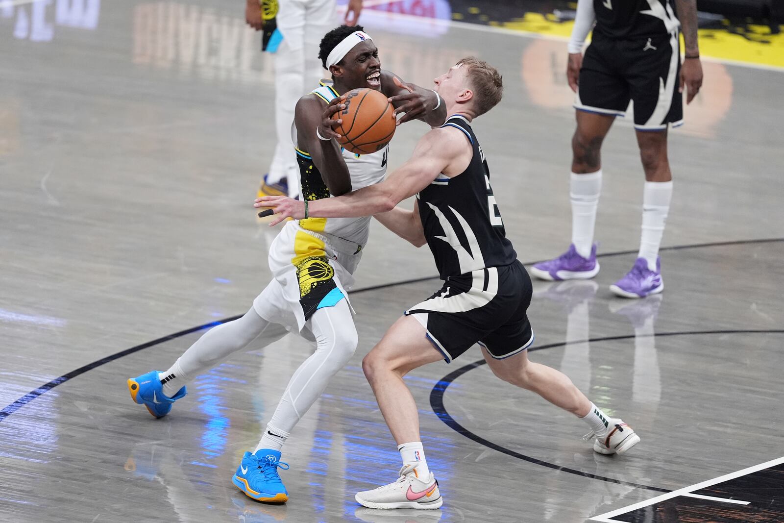 Indiana Pacers' Pascal Siakam, left, is stopped by Milwaukee Bucks' AJ Green during the second half of a first-round NBA basketball playoff game, Saturday, April 19, 2025, in Indianapolis. (AP Photo/Michael Conroy)