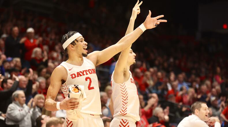 Dayton's Toumani Camara and Koby Brea celebrate a basket against Saint Louis on Friday, Feb. 10, 2023, at UD Arena. David Jablonski/Staff