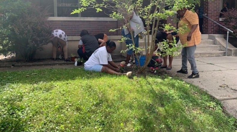 Residents and volunteers plant together at Mercy Manor. CONTRIBUTED