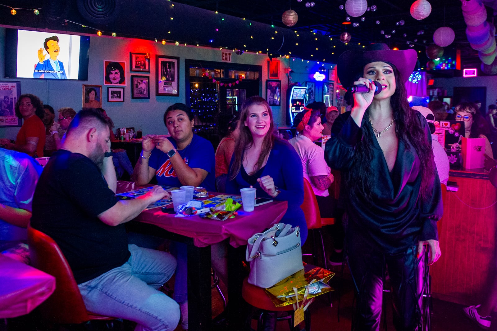 Audrey Campos speaks during a Loteria game night at Jackie O's Cocktail Club in Fort Worth, Texas, Tuesday, May 27, 2025. (AP Photo/Ronaldo Bolaños)