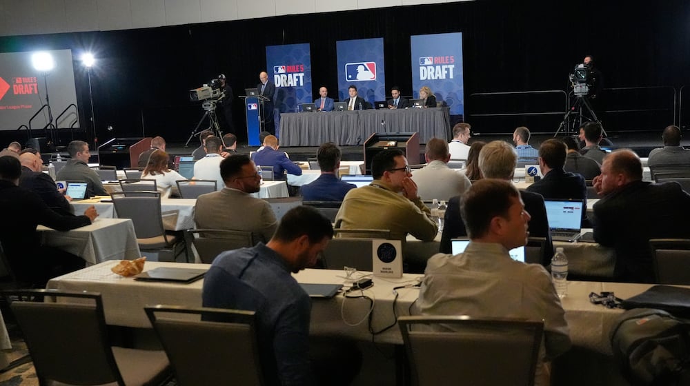 Representatives from teams watch proceedings of the MLB Rule 5 Draft at Major League Baseball's winter meetings, Wednesday, Dec. 10, 2025, in Orlando, Fla. (AP Photo/John Raoux)