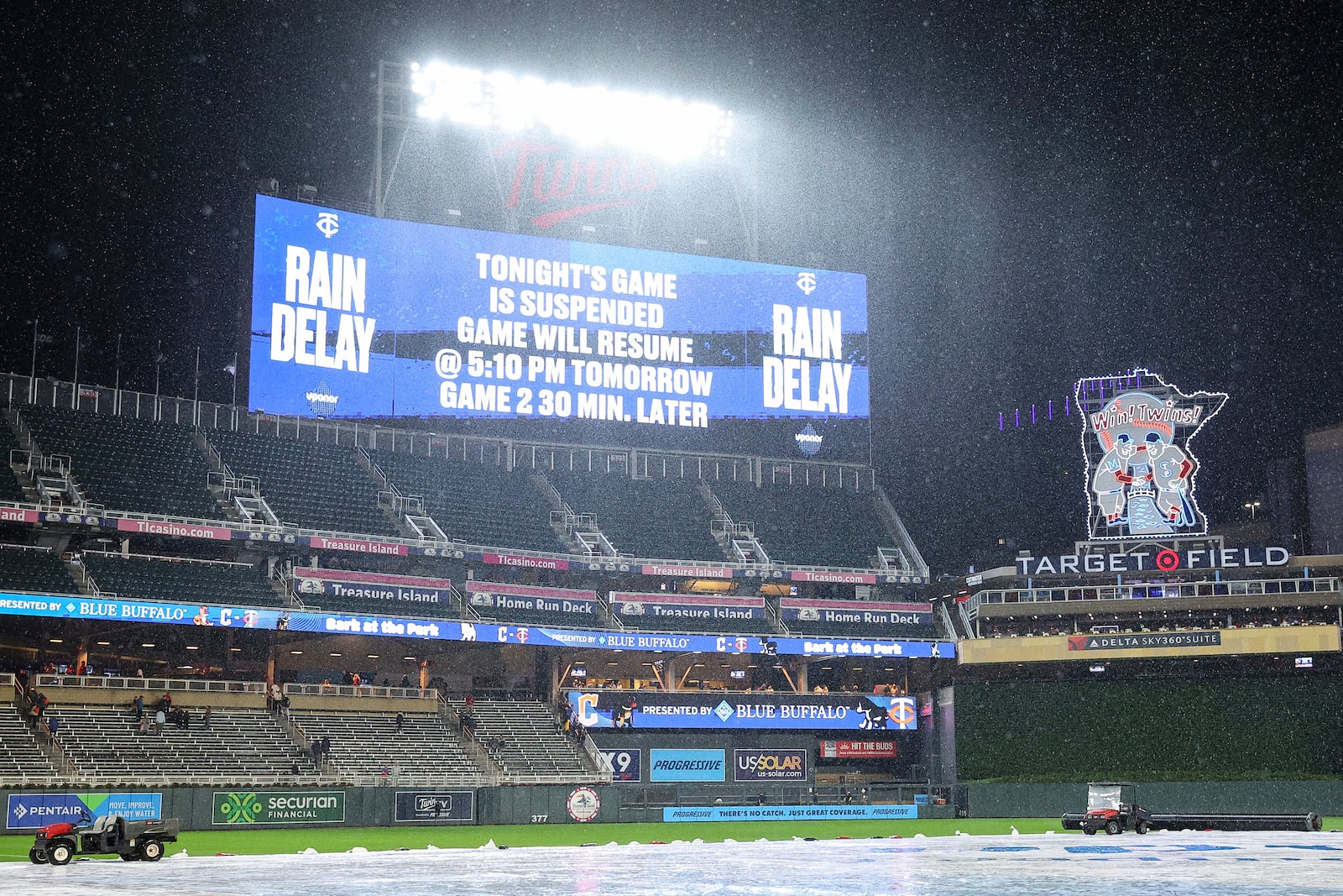 The scoreboard announces the suspension of a baseball game during the fourth inning between the Minnesota Twins and the Cleveland Guardians, Monday, May 19, 2025, in Minneapolis. (AP Photo/Matt Krohn)