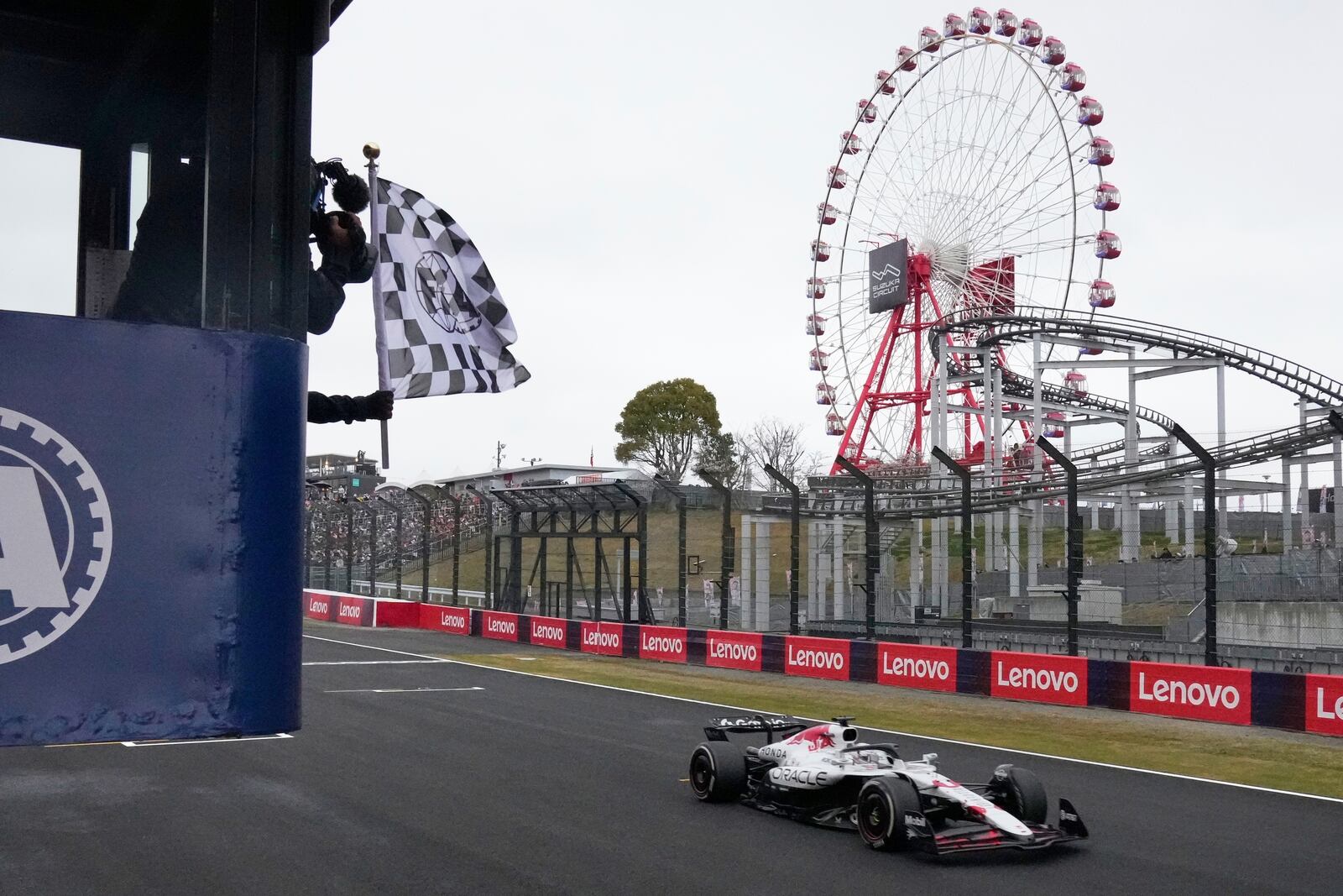 Red Bull driver Max Verstappen of the Netherlands receives the checkered flag as he crosses the finish line to win the Japanese Formula One Grand Prix at the Suzuka Circuit in Suzuka, central Japan, Sunday, April 6, 2025. (AP Photo/Shuji Kajiyama, Pool)
