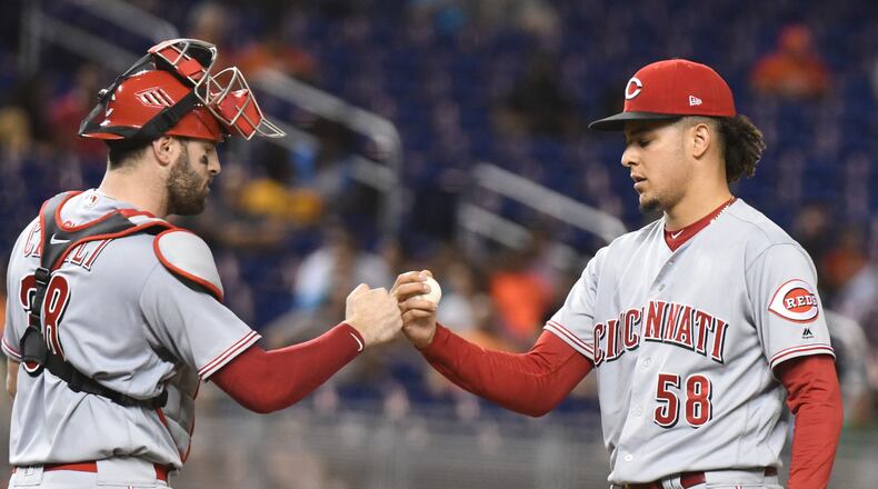 MIAMI, FL - SEPTEMBER 21: Luis Castillo #58 of the Cincinnati Reds is congratulated by Curt Casali #38 after pitching nine scoreless innings against the Miami Marlins at Marlins Park on September 21, 2018 in Miami, Florida. (Photo by Eric Espada/Getty Images)