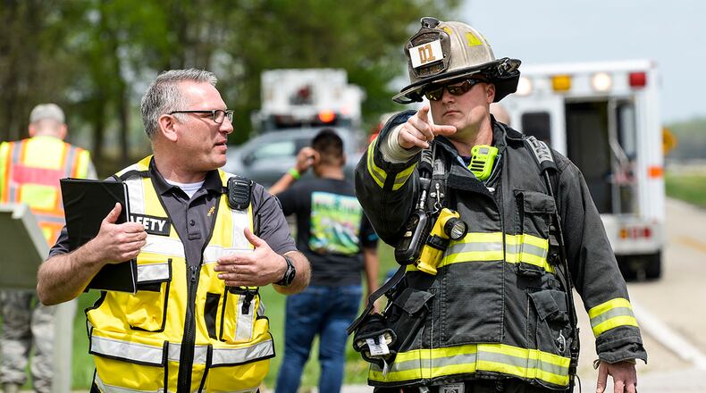 A firefighter from the 788th Civil Engineer Fire Department talks with an individual from the 88th Air Base Wing safety office during a base exercise at Huffman Prairie Flying Field, Wright-Patterson Air Force Base on May 2, 2019. U.S. AIR FORCE PHOTO/WESLEY FARNSWORTH