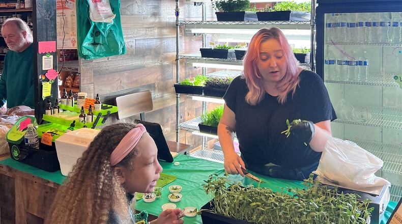 Learning about microgreens with Dayton Microgreens at 2nd Street Market. CONTRIBUTED