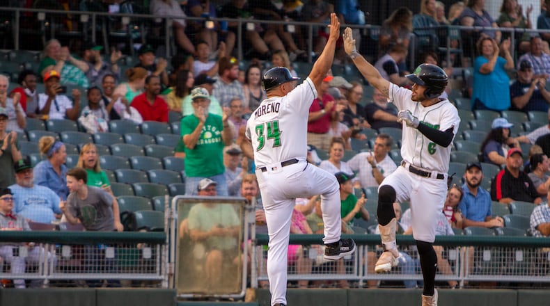 Dragons center fielder Michael Siani celebrates his lead-off homer with manager Jose Moreno in the first inning Tuesday night at Day Air Ballpark. Siani has six homers this season. Jeff Gilbert/CONTRIBUTED