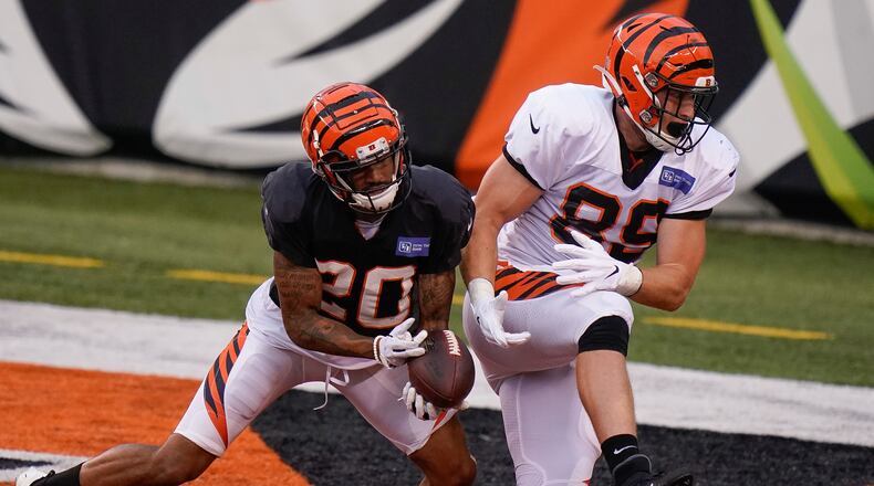 Cincinnati Bengals cornerback Torry McTyer (20) breaks up a pass to Cincinnati Bengals tight end Drew Sample (89) during an NFL football team scrimmage in Cincinnati, Sunday, Aug. 30, 2020. (AP Photo/Bryan Woolston)