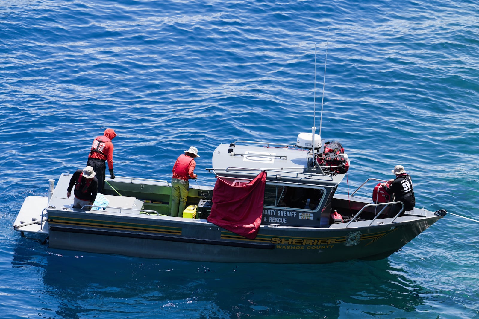 Washoe County Sheriffs conduct a search at D.L. Bliss State Park after a weekend incident in which a boat capsized, killing several people, on Monday, June 23, 2025, in Lake Tahoe, Calif. (AP Photo/Brooke Hess-Homeier)