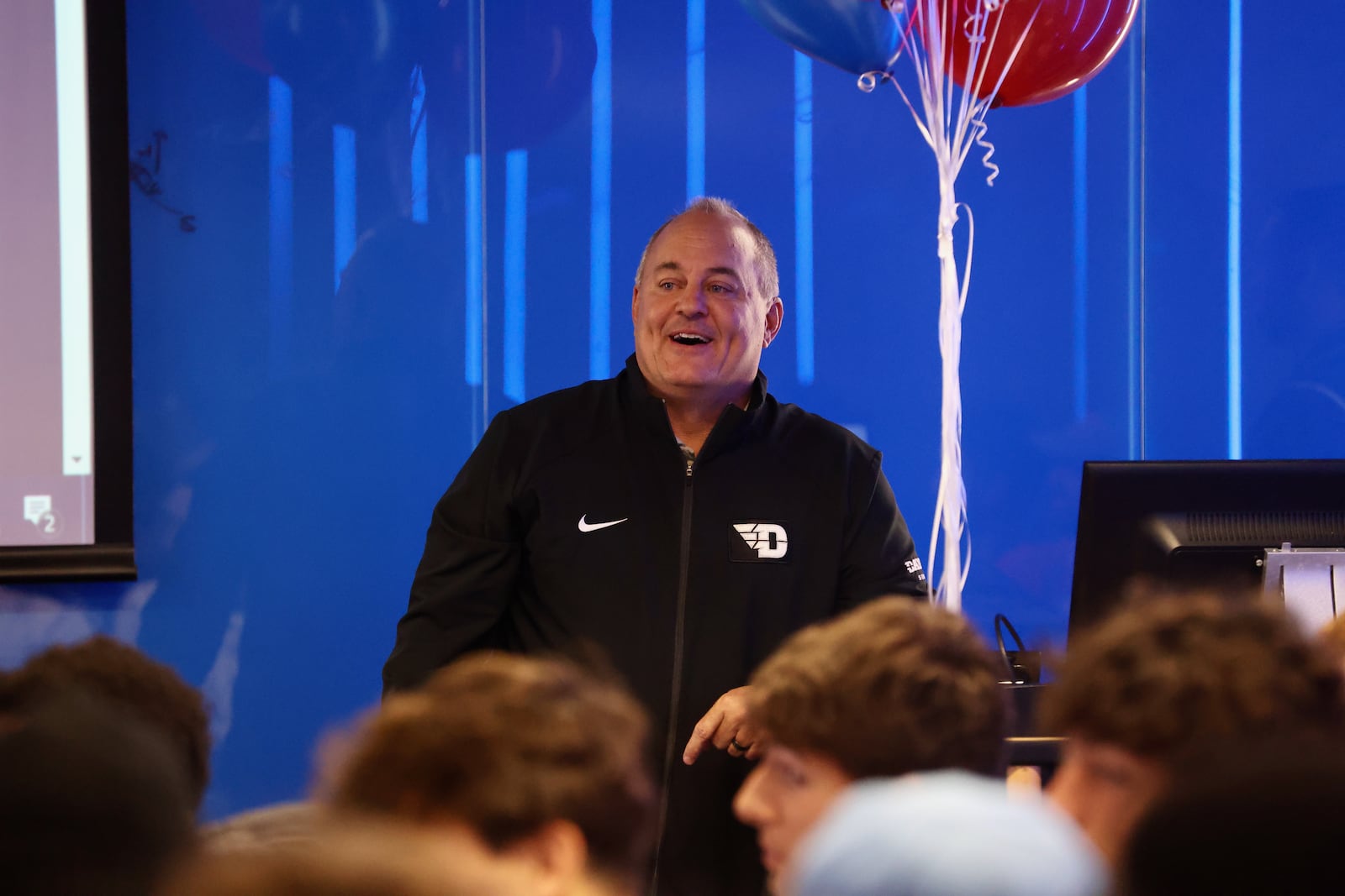 Dayton men's soccer coach Dennis Currier talks to players after they saw the team's name called during the NCAA tournament selection show on Monday, Nov. 13, 2023, at the Frericks Center. David Jablonski/Staff