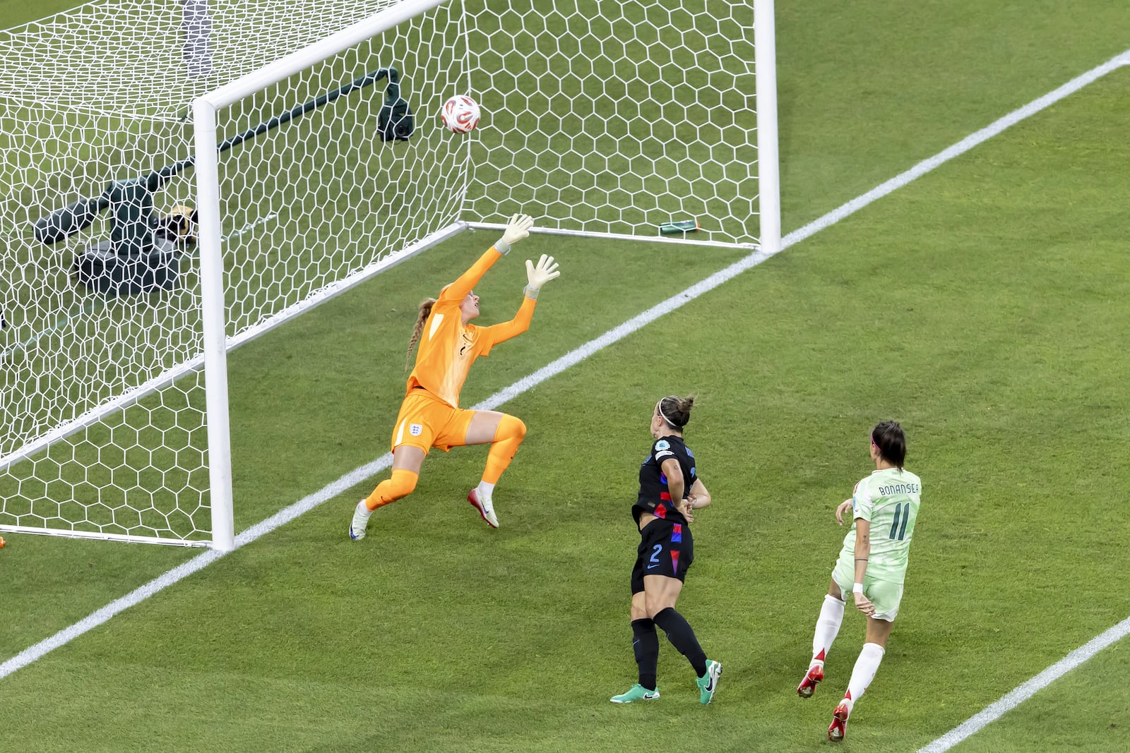 Italy's Barbara Bonansea, right, scores the opening goal past England's goalkeeper Hannah Hampton during the Women's Euro 2025 semifinals soccer match between England and Italy at Stade de Geneve in Geneva, Switzerland, Tuesday, July 22, 2025. (Salvatore Di Nolfi/Keystone via AP)