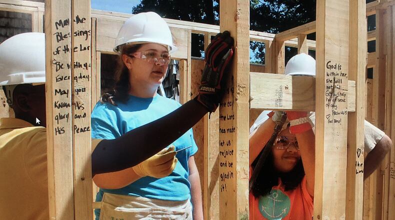 Urbana is the location of the newest Habitat for Humanity House and students were the builders this past week. A youth group of 13 students from Saint George’s Episcopal Church in Dayton is on their third year volunteering for Habitat for Humanity. The students are overseen by church volunteer Anoopa Hodges. Jeff Guerini/STAFF