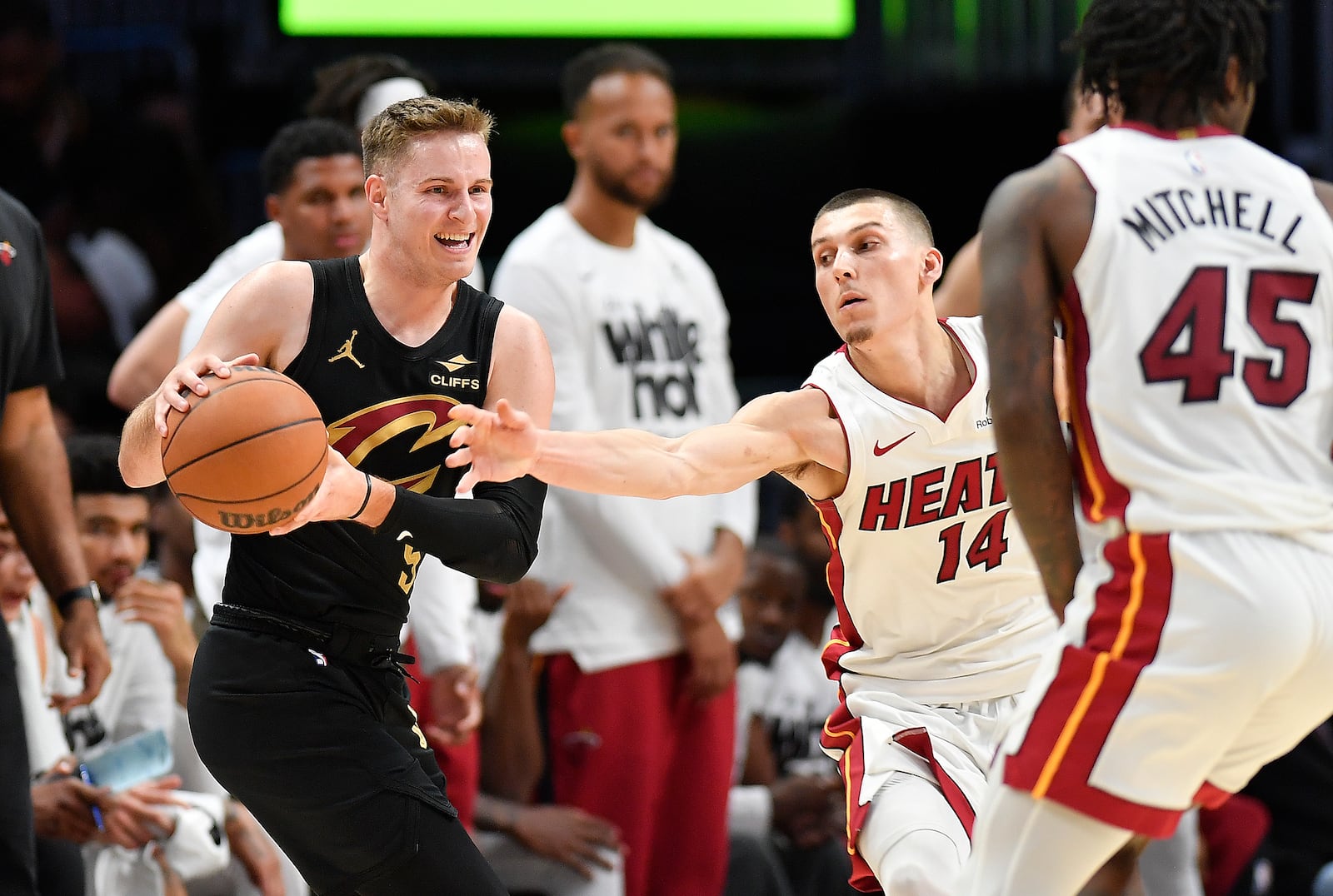Cleveland Cavaliers guard Sam Merrill (5) keeps the ball away from Miami Heat guard Tyler Herro (14) during the first half in Game 3 of an NBA basketball first-round playoff series, Saturday, April 26, 2025, in Miami. (AP Photo/Michael Laughlin)