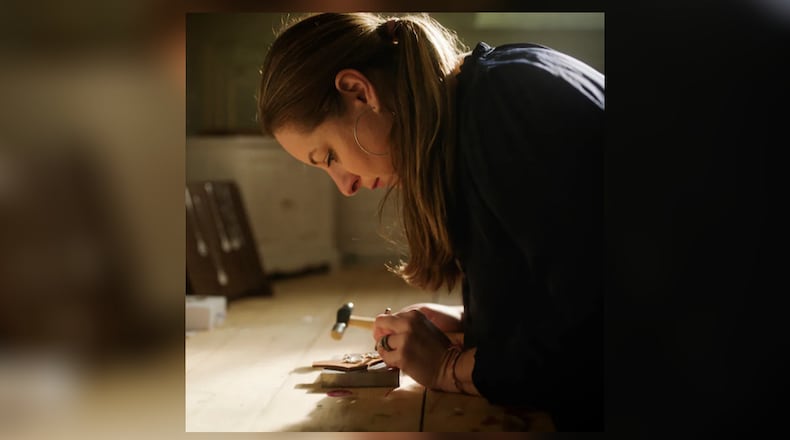 In the early days, Traveling Pendant founder Lesley Jones hand-stamped every pendant herself. After a slipped disc forced her to pause, she reimagined the brand with a team and new QR code technology — building a more sustainable way to scale while staying true to the heart of the mission. CONTRIBUTED