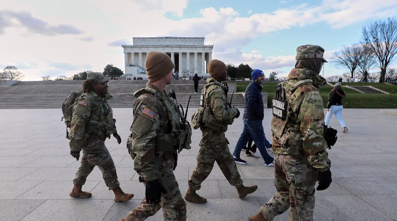 National Guard patrol the National Mall near the Lincoln Memorial, Friday, Nov. 28, 2025, in Washington. (AP Photo/Rahmat Gul)