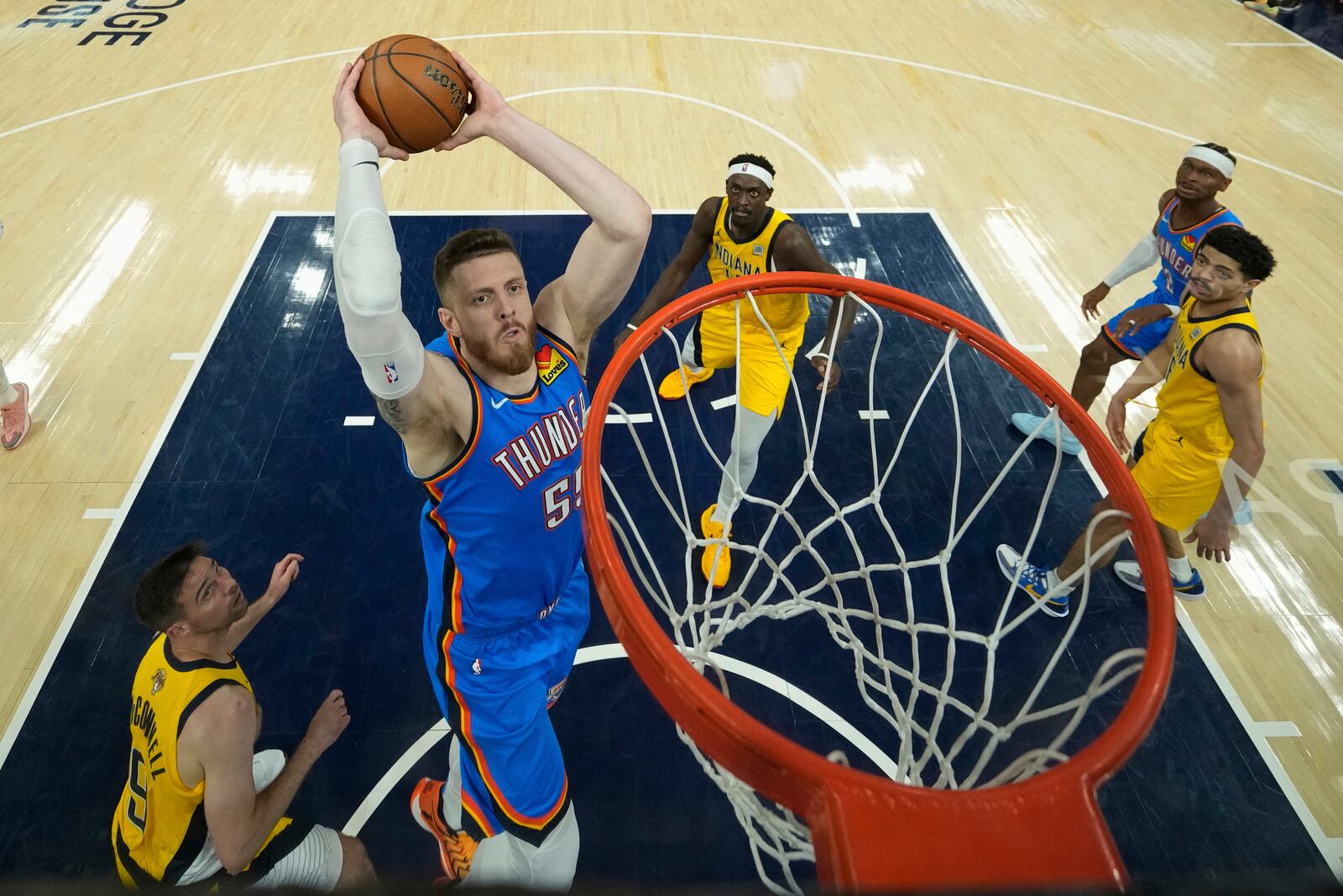 Oklahoma City Thunder center Isaiah Hartenstein (55) dunks against the Indiana Pacers during the first half of Game 3 of the NBA Finals basketball series, Wednesday, June 11, 2025, in Indianapolis. (AP Photo/Abbie Parr)
