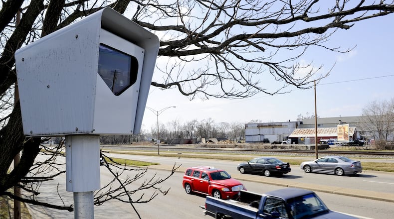Vehicles pass by a red light camera in Middletown.