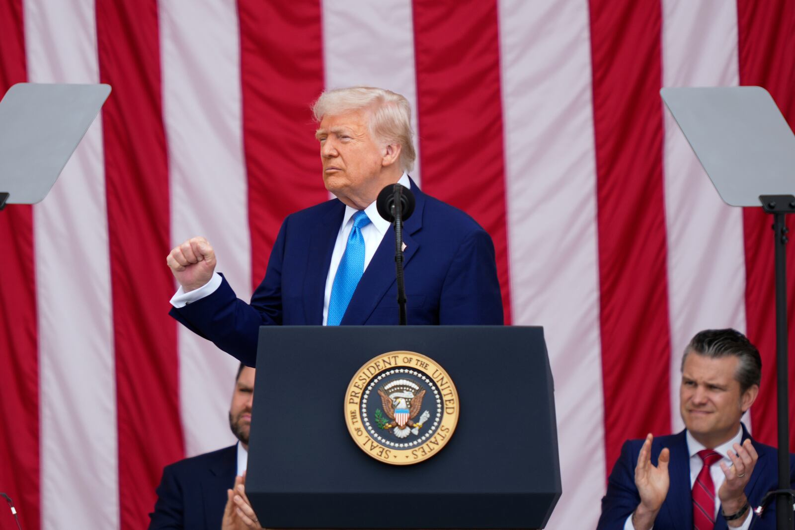 President Donald Trump delivers the Memorial Day Address at the 157th National Memorial Day Observance at Arlington National Cemetery, Monday, May 26, 2025, in Arlington, Va., as Vice President JD Vance and Secretary of Defense Pete Hegseth, right, look on. (AP Photo/Julia Demaree Nikhinson)