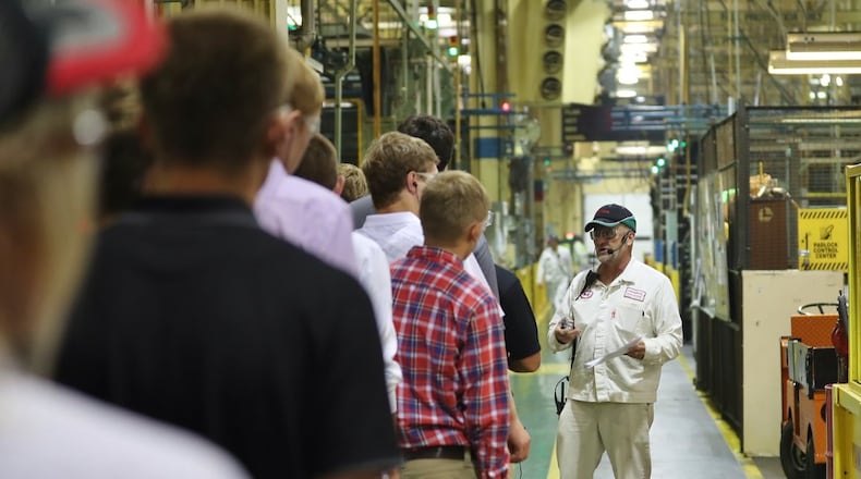 Anna Engine Plant staff member Mark Bollheimer hosts a tour with area high school students during Manufacturing Day, in a Honda photograph taken last October. CONTRIBUTED