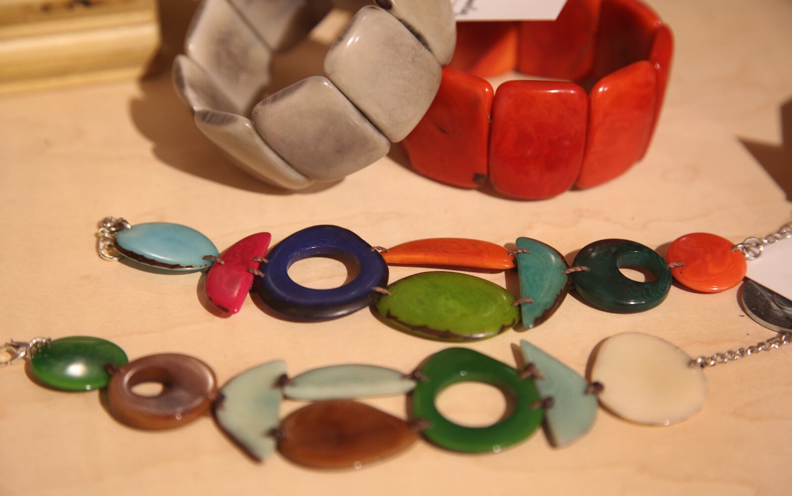 Colorful âearth friendlyâ jewelry created by Tabatha Hemmerling is made from a variety of nuts and seeds. Varying shapes and sizes could be from tagua nuts found in the Amazon rainforest, acai seeds or coconut peel. Bracelets start at $38 and necklaces go up to $149. LISA POWELL / STAFF