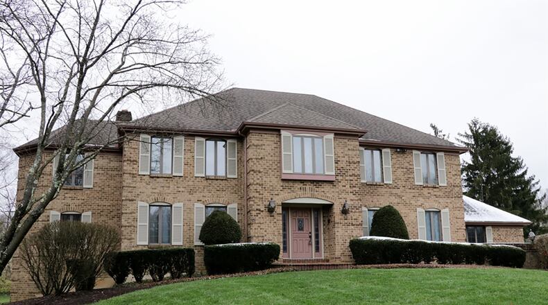 The 2-story house with about 5,650 sq. ft. of living space, including the finished walk-out lower level, has a 3-car, side-entry garage and a second garden garage. A bonus study built into a turret is off the family room and a sitting room is off the upstairs main bedroom. CONTRIBUTED PHOTO BY KATHY TYLER