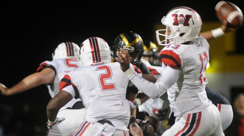 Wayne QB Rashad McKee unloads a pass while Fred Pitts blocks. Wayne defeated host Centerville 45-8 in a GWOC National East Division Week 6 game on Friday, Sept. 30, 2016. MARC PENDLETON / STAFF
