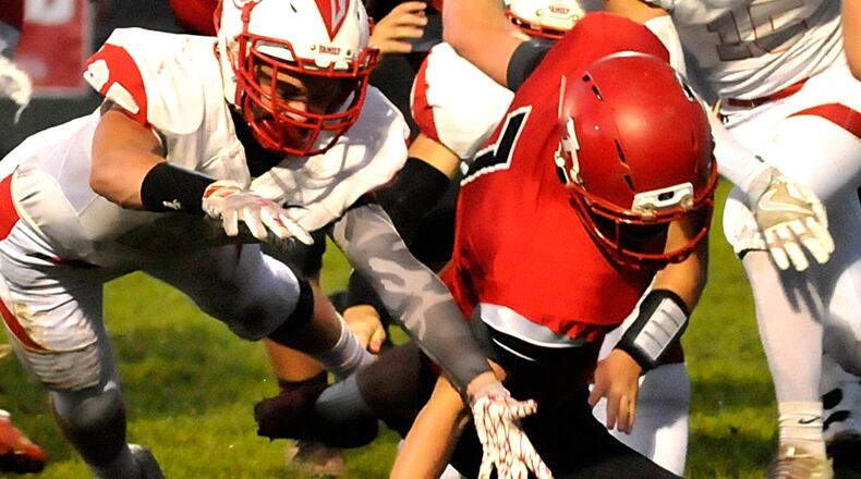 Madison’s Mason Whiteman (7) recovers his own fumble during the second quarter of a Southwestern Buckeye League game against Carlisle on Oct. 7. CONTRIBUTED PHOTO BY DAVID A. MOODIE