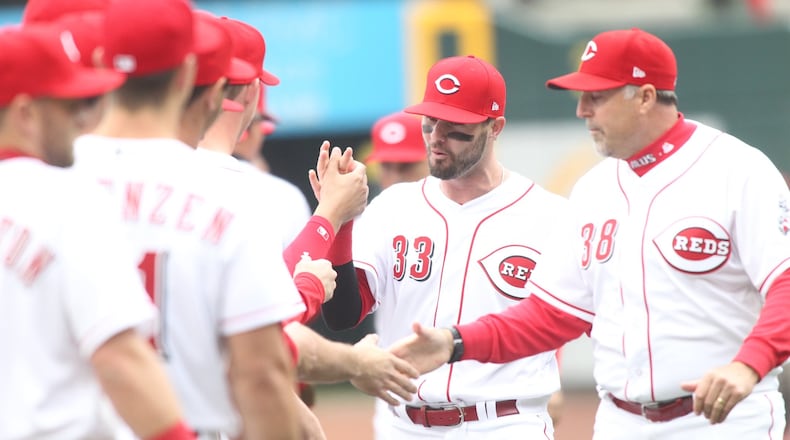Reds outfielder Jesse Winker (33) and manager Bryan Price are introduced prior to Friday’s Opening Day game vs. the Nationals at Great American Ball Park. David Jablonski/STAFF
