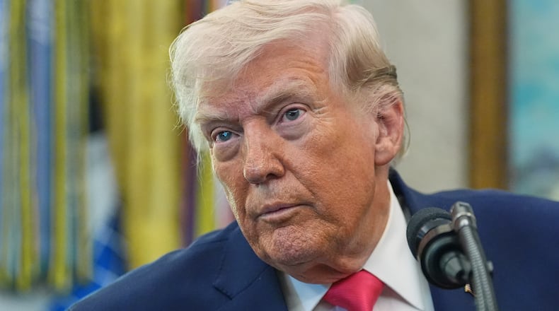 President Donald Trump listens to a reporter during the swearing in for Homeland Security Secretary Markwayne Mullin in the Oval Office of the White House, Tuesday, March 24, 2026, in Washington. (AP Photo/Alex Brandon)