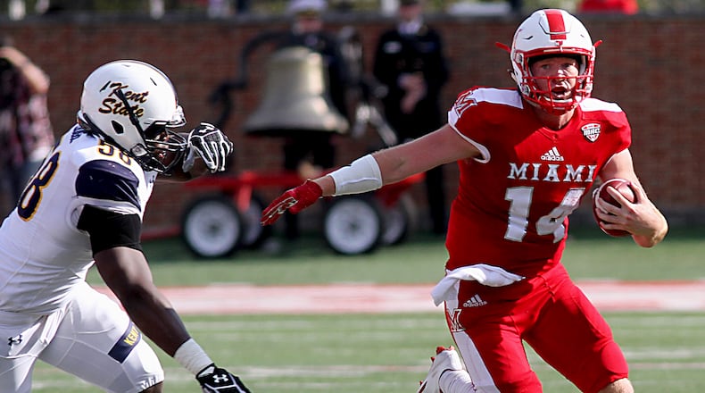 Miami quarterback Gus Ragland gets away from Kent State defensive end Theo Eboigbe on his way to first down yardage during their game at Yager Stadium in Oxford Saturday, Oct. 15, 2016. Contributed Photo / E.L. Hubbard