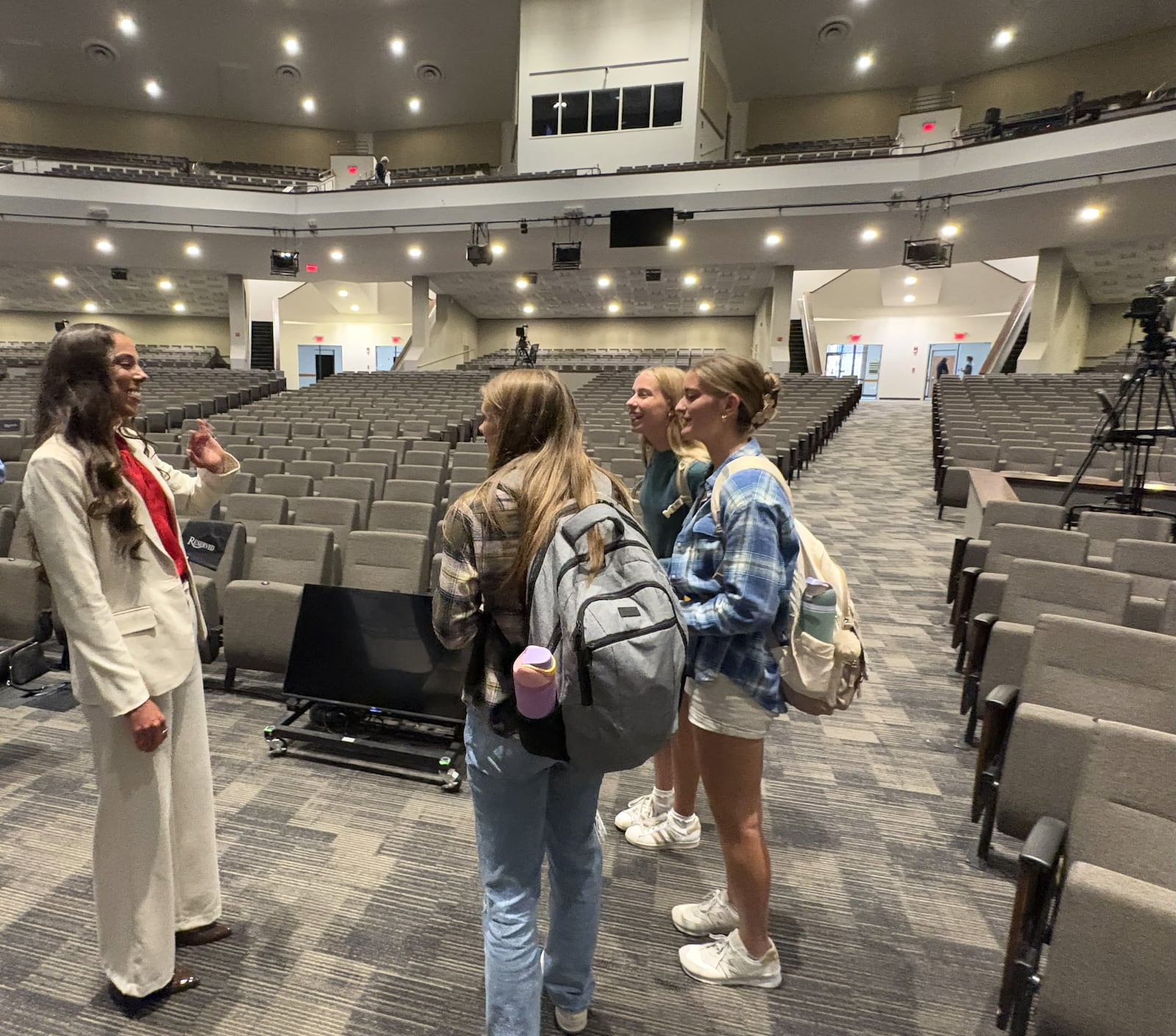 Following her well-received talk to over 3,400 students in the Cedarville University chapel Wednesday, Grace Norman, the school’s Young Alumna of the Year honoree, had been swarmed by students who appreciated her message. After nearly 20 minutes of meeting with dozens of students who’d lined up, she met with the final three in line: Summer Swartwout (with backpack); Bekah Brinser (blue shirt); and Mallory Gasper (green shirt), all members Cedarville track team. TOM ARCHDEACON / CONTRIBUTED PHOTO