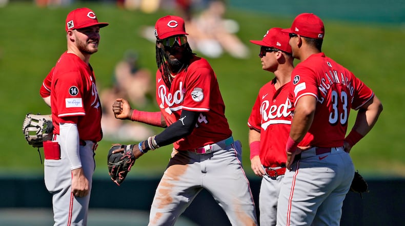 From left; Cincinnati Reds' Gavin Lux, Elly De La Cruz, Matt McLain, and Christian Encarnacion-Strand talk during a pitching change against the Los Angeles Angels during the second inning of a spring training baseball game, Wednesday, Feb. 26, 2025, in Tempe, Ariz. (AP Photo/Matt York)