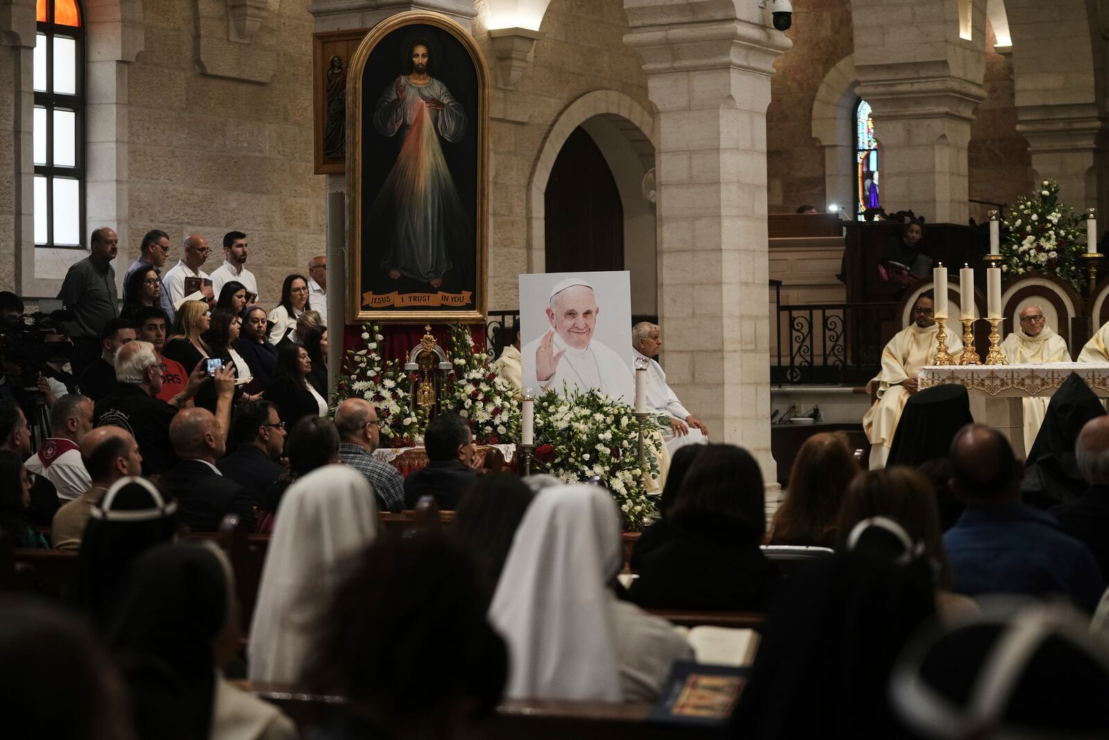 Worshippers attend a memorial mass to commemorate the late Pope Francis at the Church of the Nativity, traditionally believed to be the birthplace of Jesus Christ, in the West Bank town of Bethlehem, Saturday, April 26, 2025. (AP Photo/Mahmoud Illean)