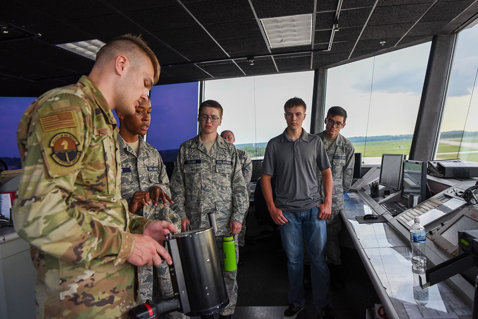 Airman 1st Class Brandon King (left), air traffic control apprentice with the 88th Operations Support Squadron, shows cadets from the Civil Air Patrol’s 037 Wright-Patterson Composite Squadron different tools used in the tower June 29 during their tour of the Base Operations Building at Wright-Patterson Air Force Base. U.S. AIR FORCE PHOTO/AIRMAN 1ST CLASS ALEXANDRIA FULTON
