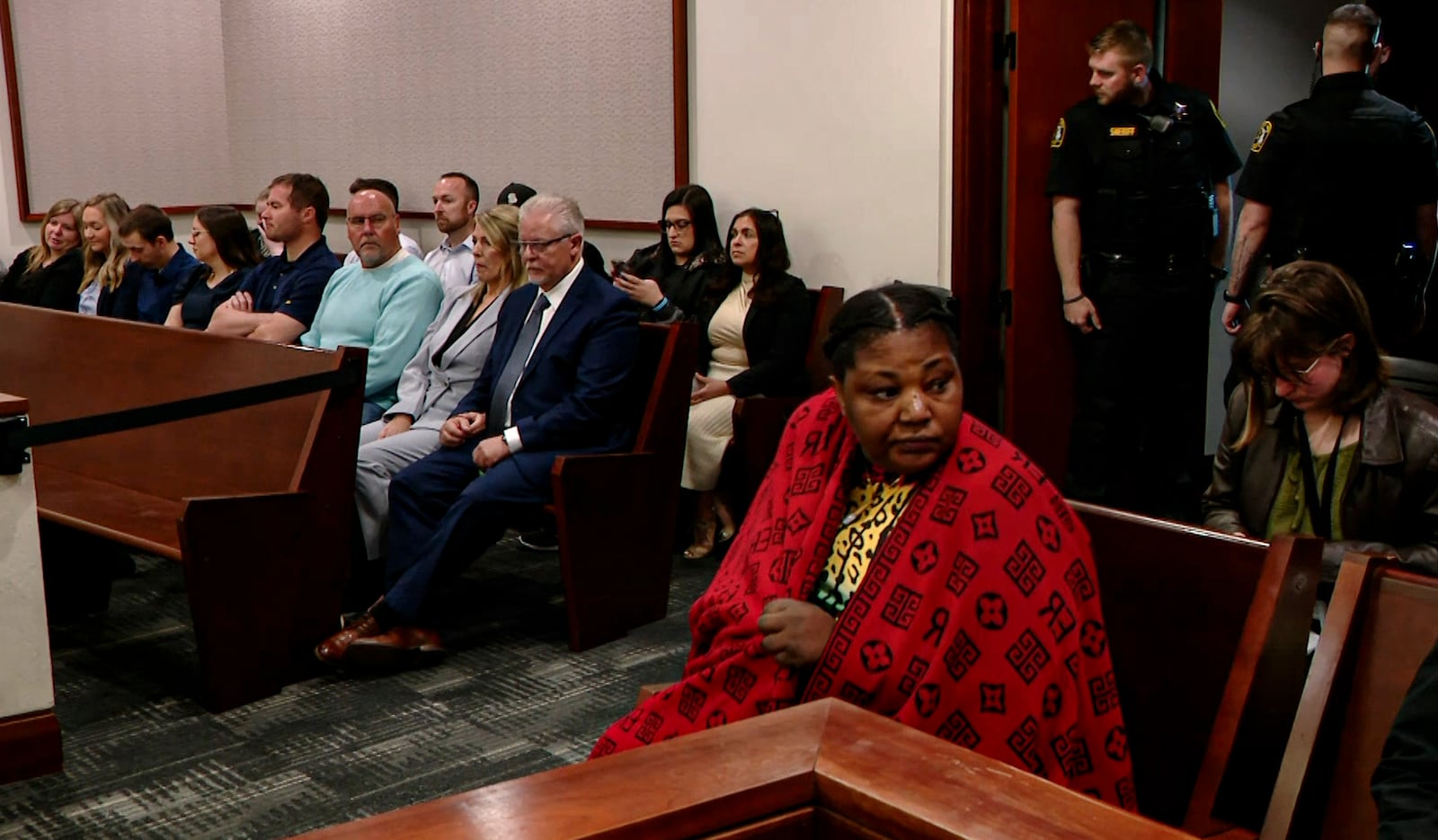 This video image provided by WOOD-TV shows Patrick Lyoya's mother, Dorcas, sits in court on the first day of Christopher Schurr's trial in the Kent County Courthouse in Grand Rapids, Mich. on Monday, April 28, 2025. (WOOD-TV via AP, Pool)