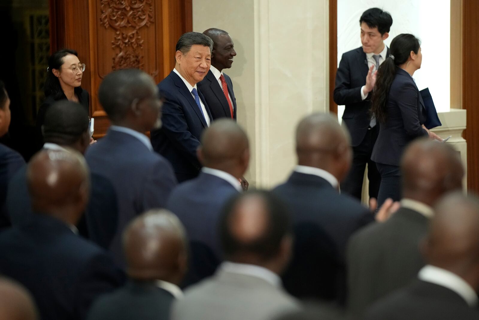Chinese President Xi Jinping, center left, and Kenyan President William Ruto, center right, attend a signing ceremony a signing ceremony at the Great Hall of the People in Beijing Thursday, April 24, 2025. (Iori Sagisawa/Pool Photo via AP)