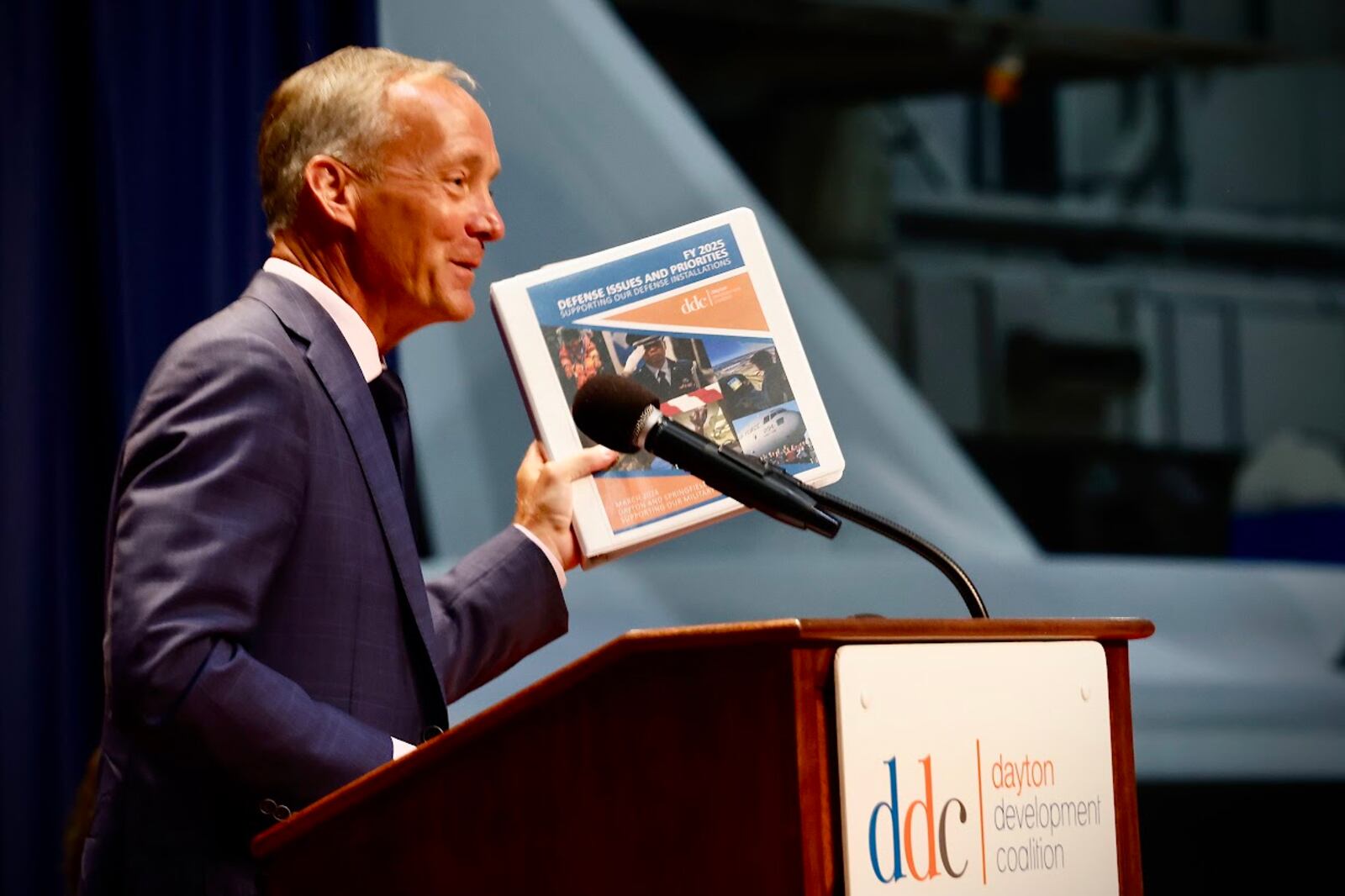 Jeff Hoagland, president and chief executive of the Dayton Development Coalition, holding a copy of the coalition's strategic plan. MARSHALL GORBY/STAFF