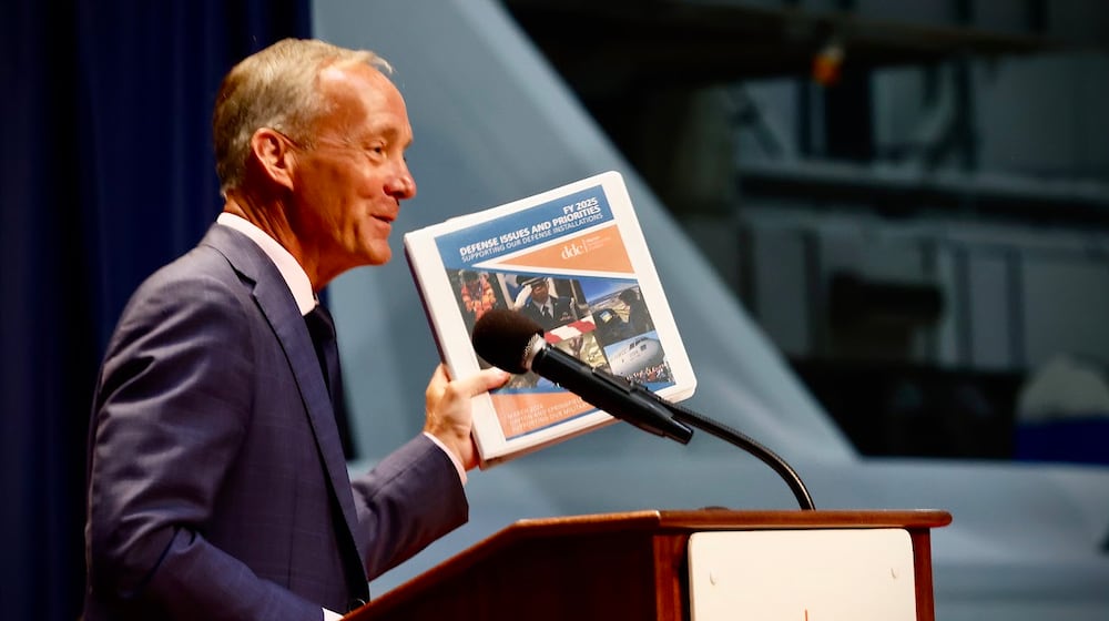 Jeff Hoagland, president and chief executive of the Dayton Development Coalition, holding a copy of the coalition's strategic plan. MARSHALL GORBY/STAFF
