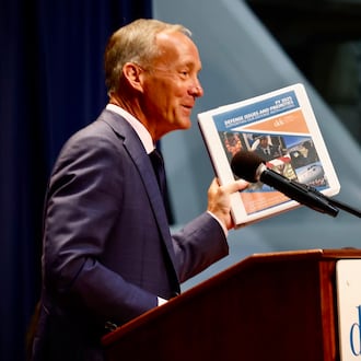 Jeff Hoagland, president and chief executive of the Dayton Development Coalition, holding a copy of the coalition's strategic plan. MARSHALL GORBY/STAFF